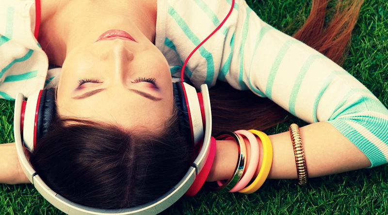 Young woman listening to the music .